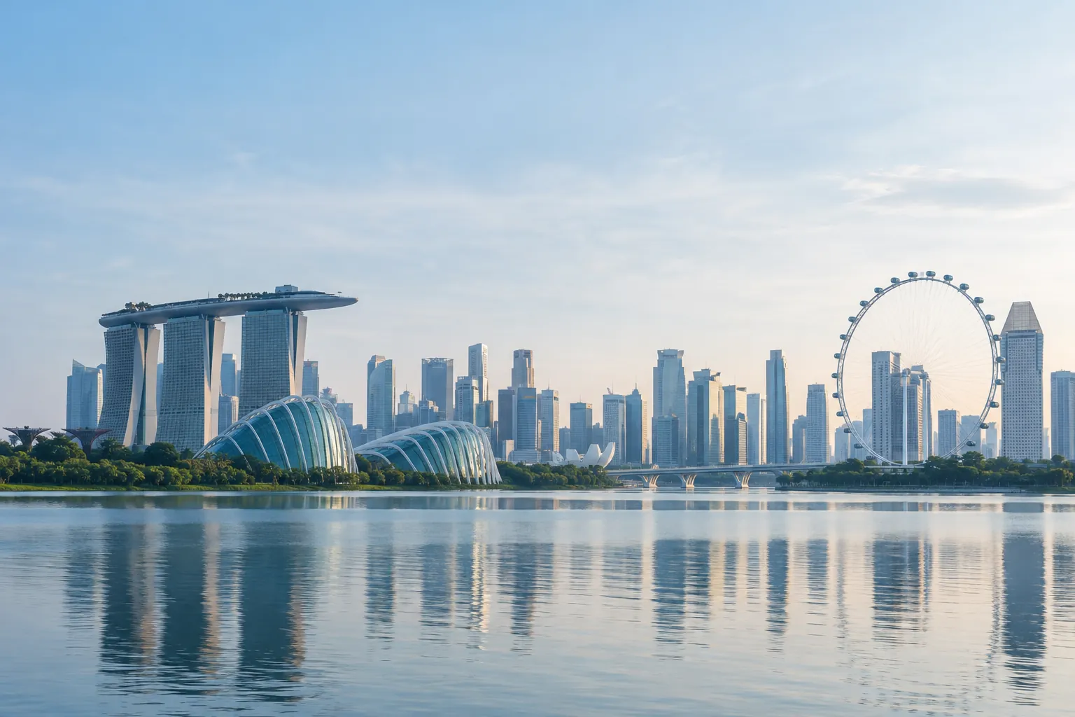 The Singapore skyline across calm water in the morning